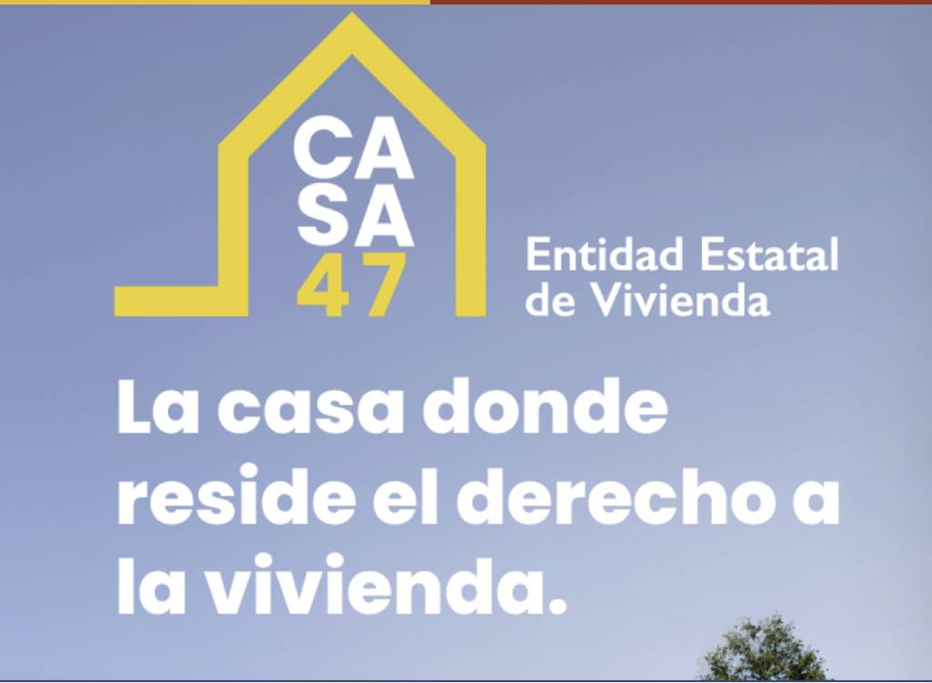 Plan Estatal Vivienda 2026 funcionarios Madrid: bloque de vivienda pública con bandera de España